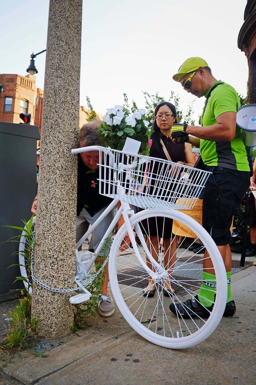 Photo of Peter Cheung with a ghost bike